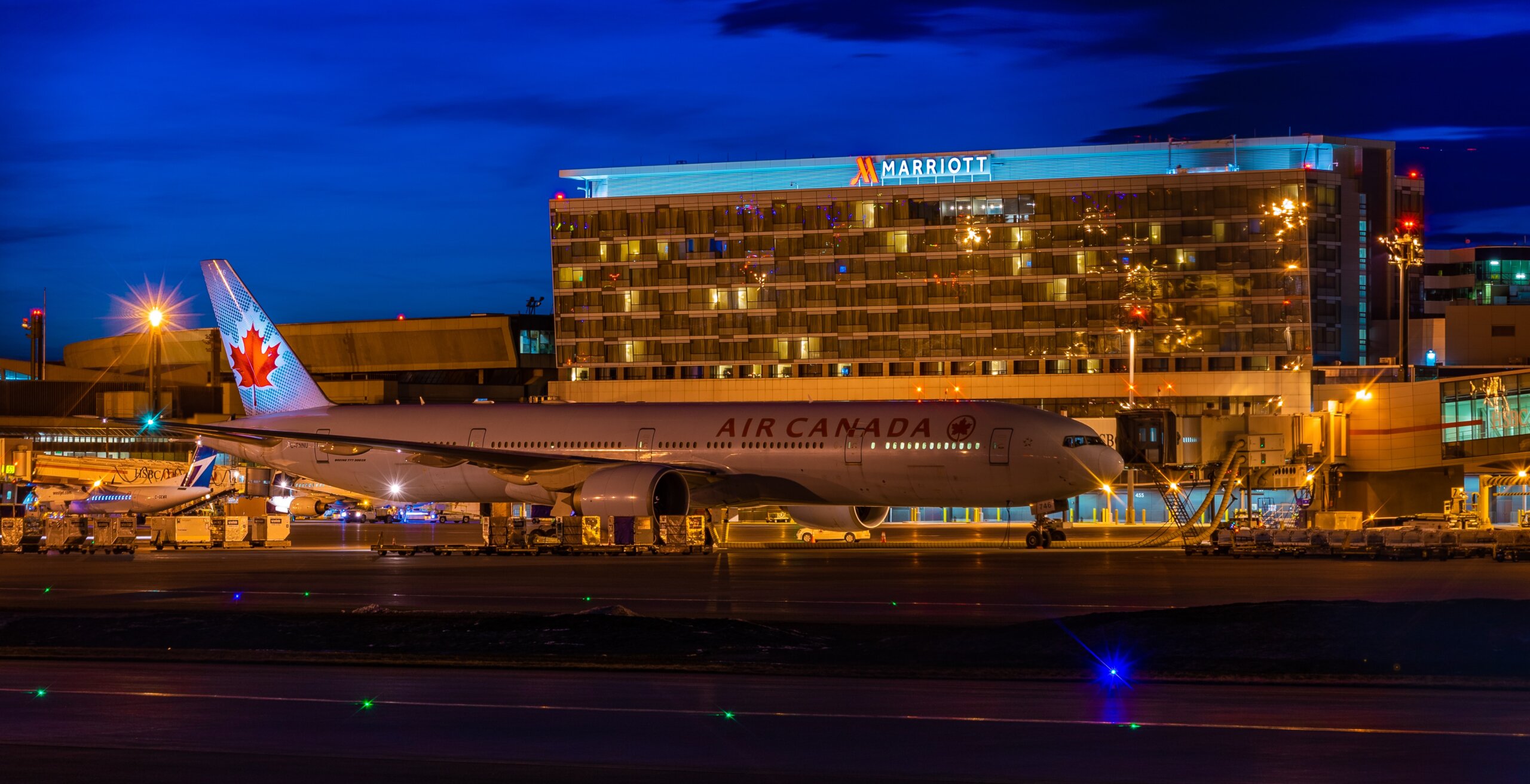 Air Canada airplane on runway in front of Marriott hotel