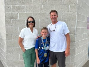 Man and woman with boy in soccer uniform