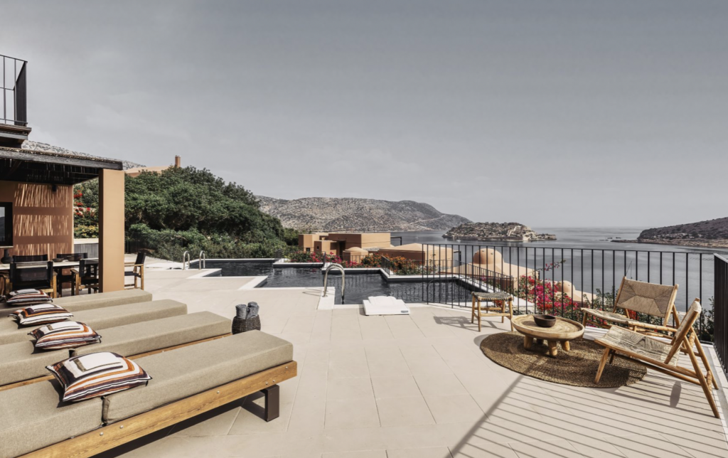 Pool are of hotel with view of ocean.