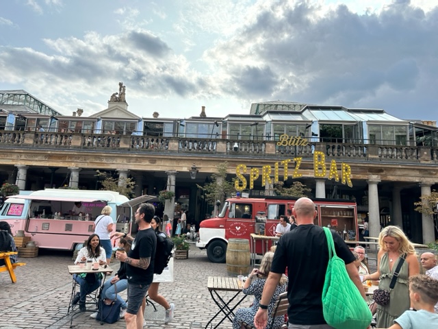 Buildings with people outside and pink van