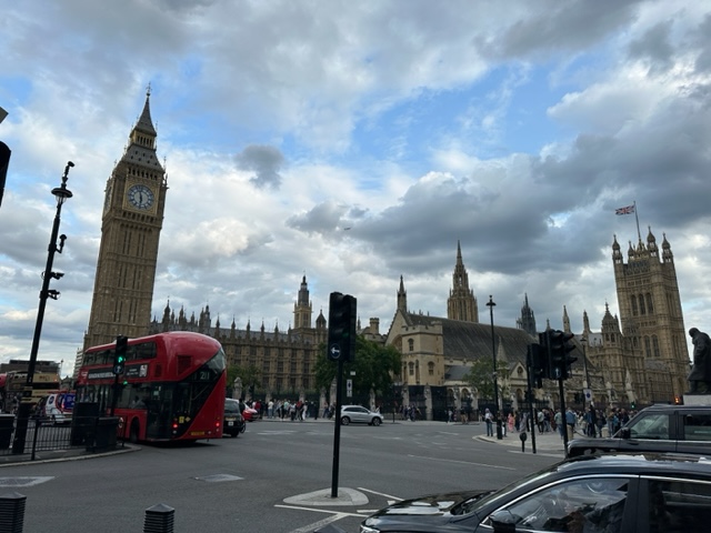 Big tower with red bus near buy