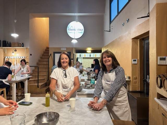 Two women making pizza