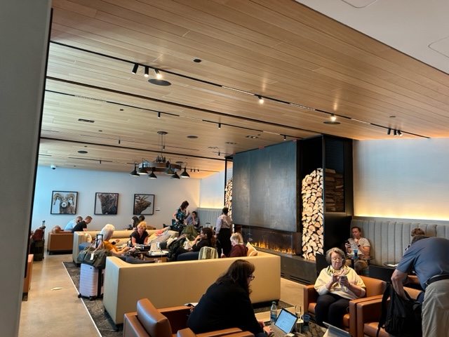 Airport lounge with seating area and fireplace