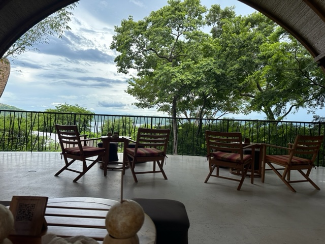 Table and chairs overlooking water.