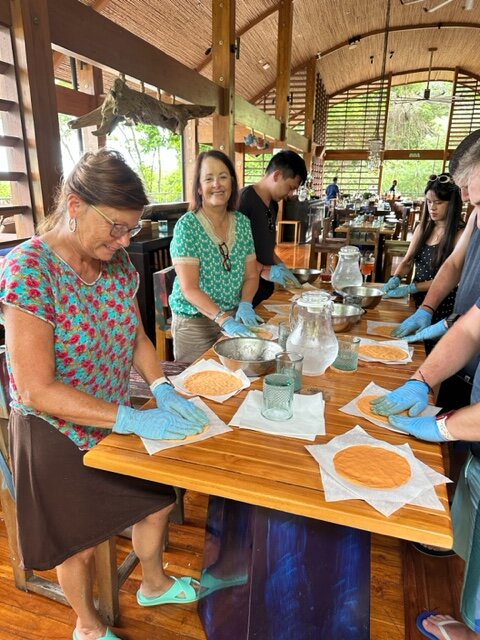 People making food on table.