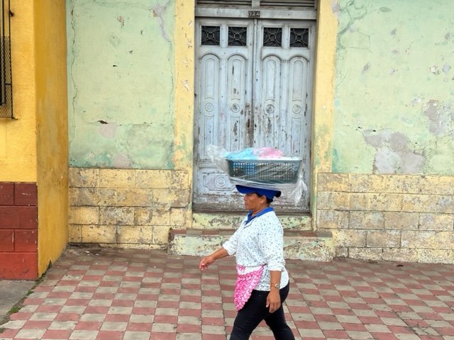 woman walking with bowl on her head