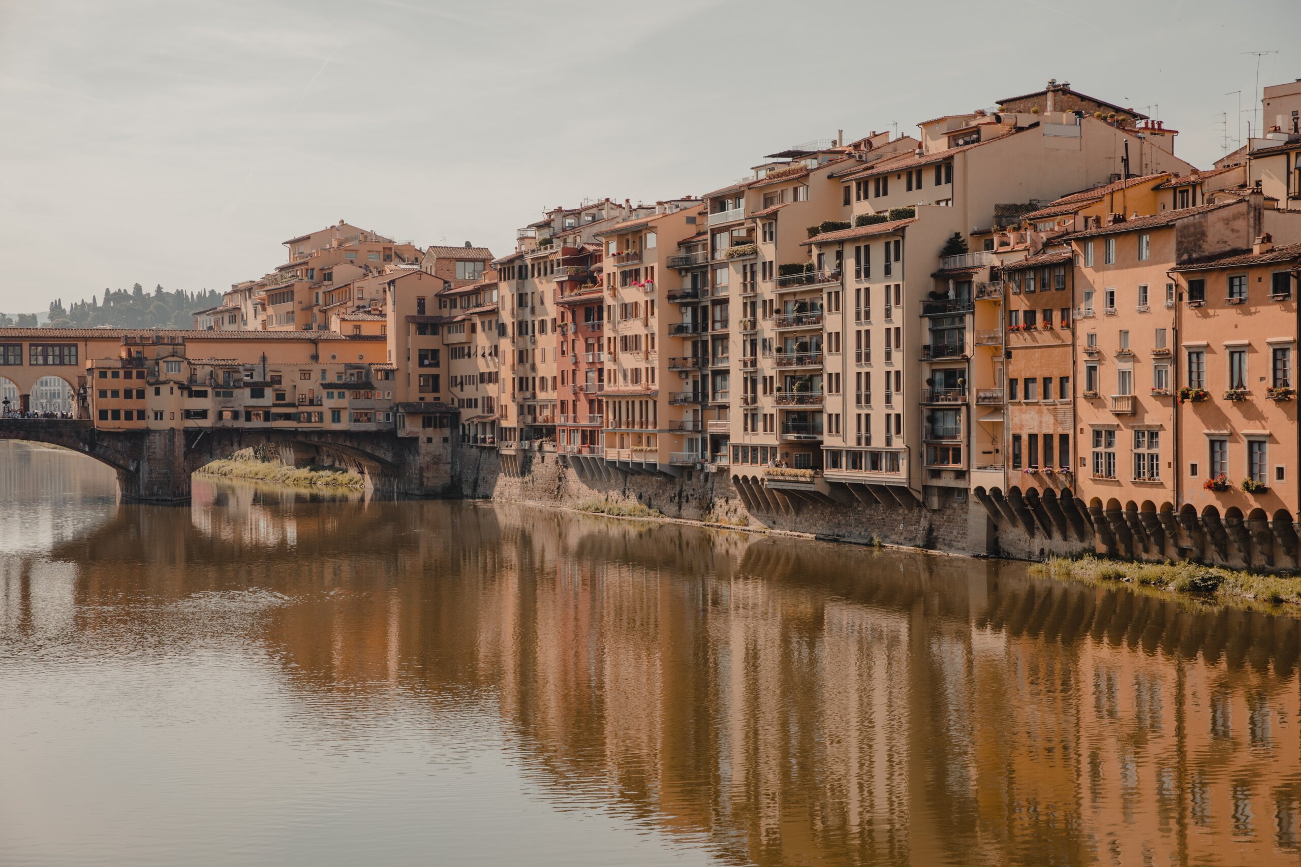 Yellow and rust colored homes on side of river