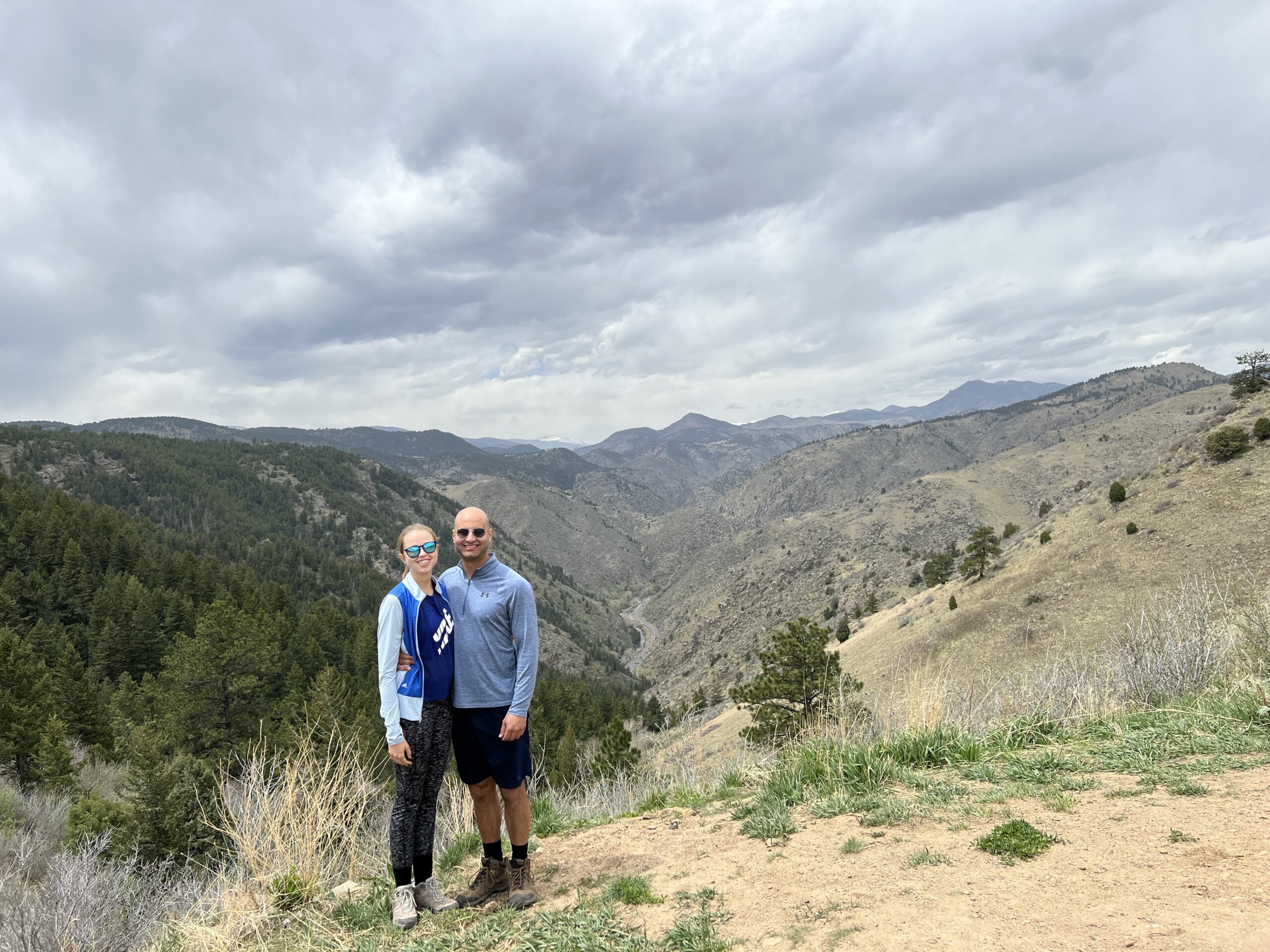 Man and woman standing on top of mountain