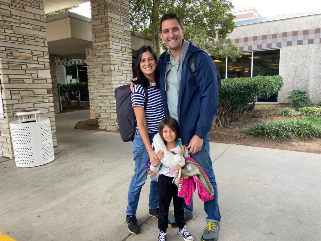 Man, woman, and girl with backpacks