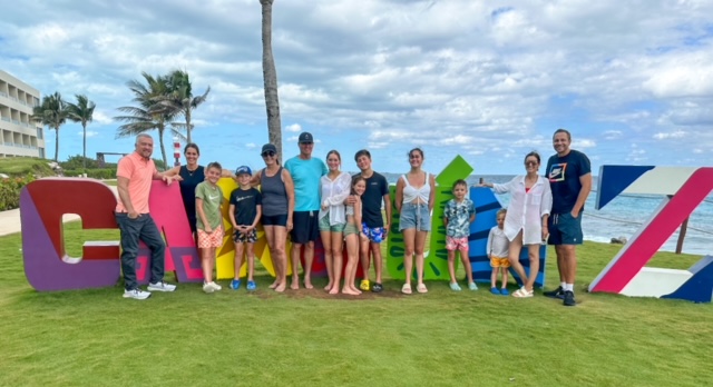 Large family near Cancun sign at Hyatt all-inclusive in Mexico