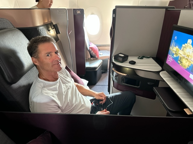 Man in business class seat.