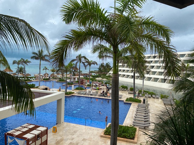 Resort with blue pool and palm trees