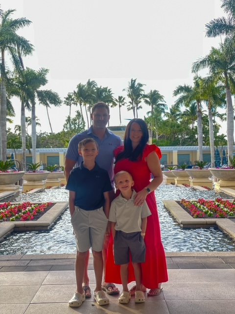 Family of four in front of pool