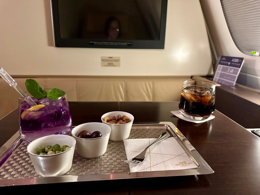 Small bowls with nuts and olives.