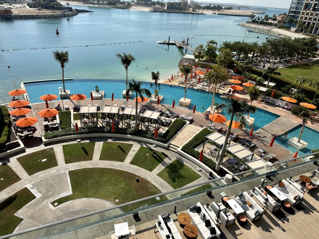 Hotel pool area with orange umbrellas.