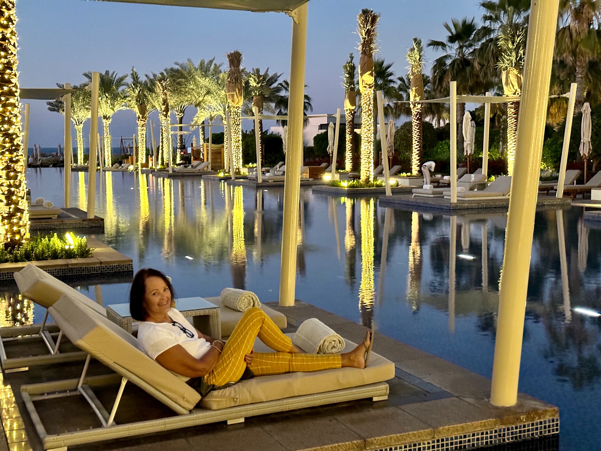 Woman on lounge chair by pool