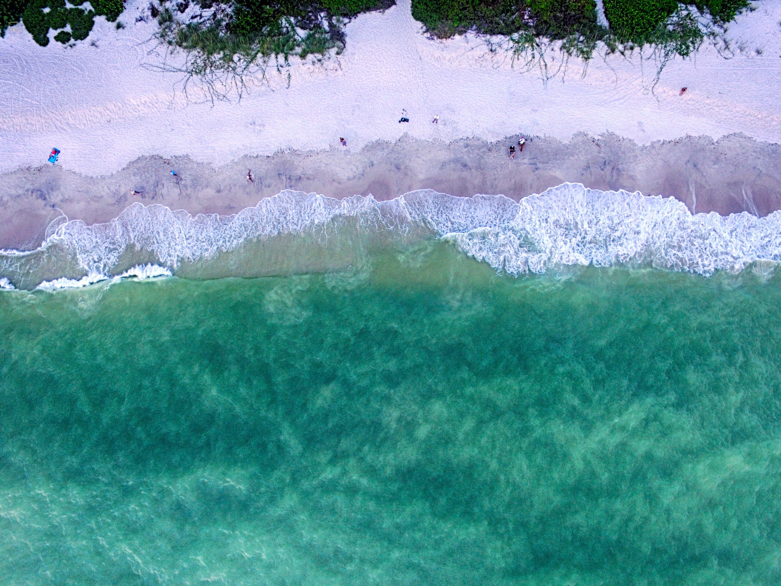 Aerial view of white sand and turquoise water