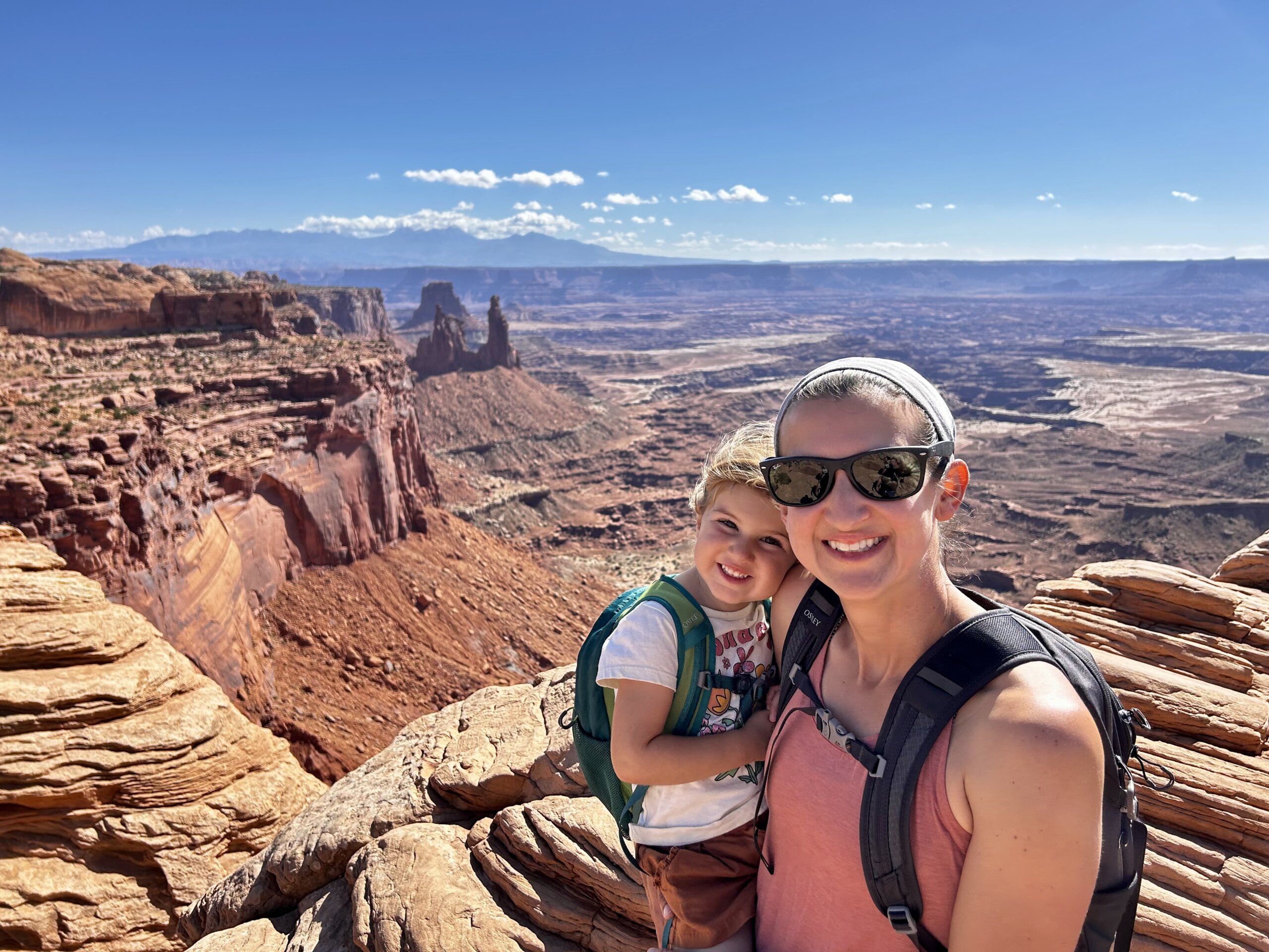 Women and little girl in front of red rocks