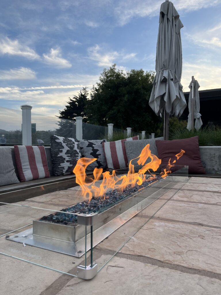 Pool area with fire pit at hotel.