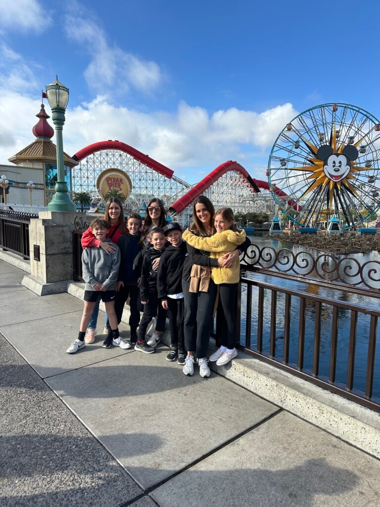 Family of women and children in front of Ferris Wheel