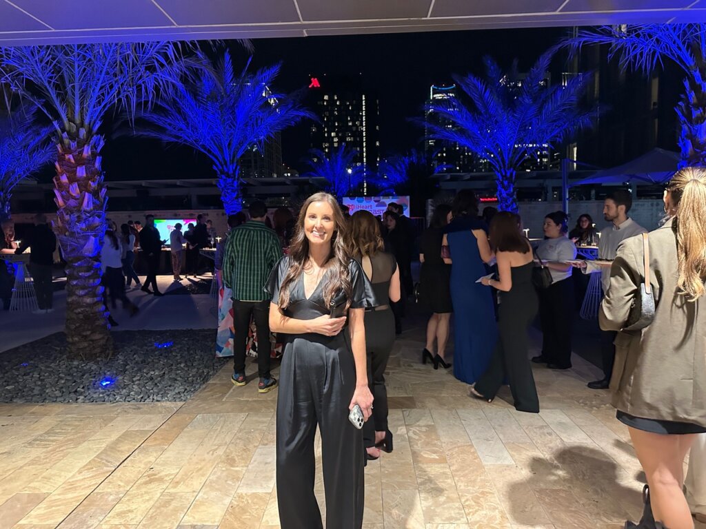 Girl standing in front of people at party