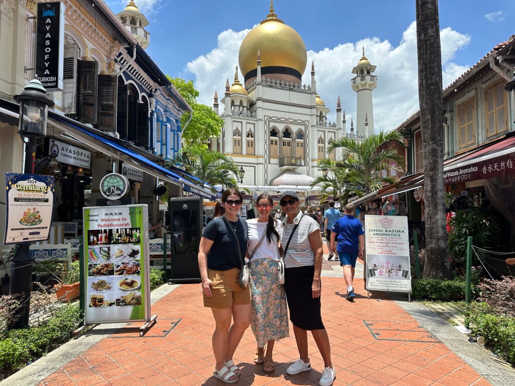 Three women in front of mosque