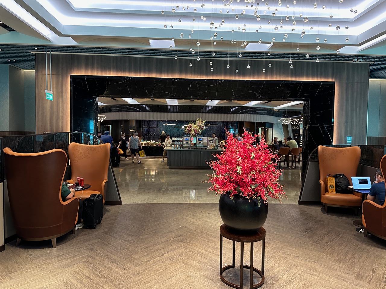 Airport lounge with red flowers in vase