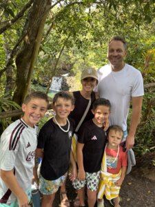 family in maui near a waterfall