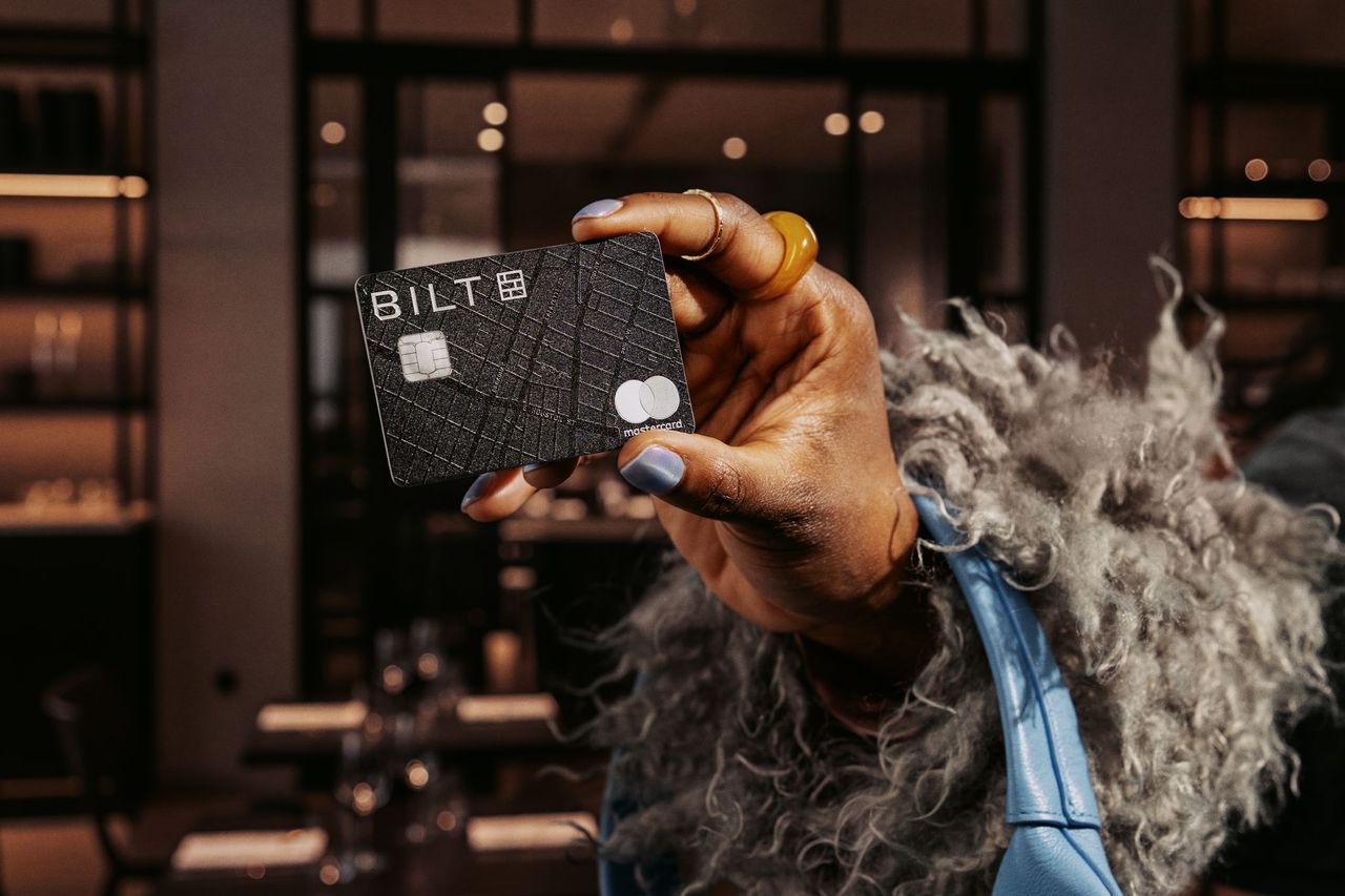 Hand holding a black Bilt credit card