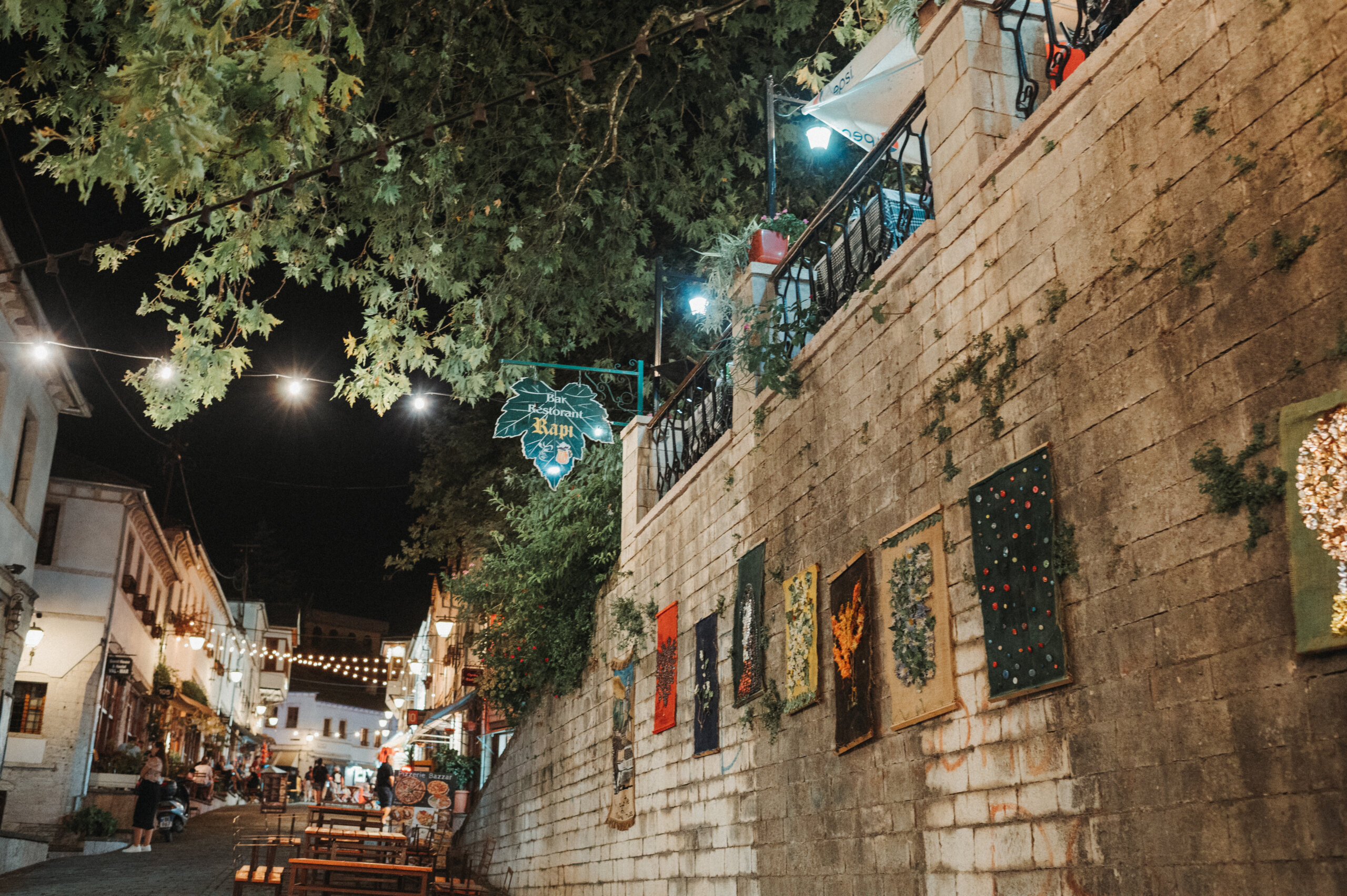 Old Albanian alley way lined by a large wall