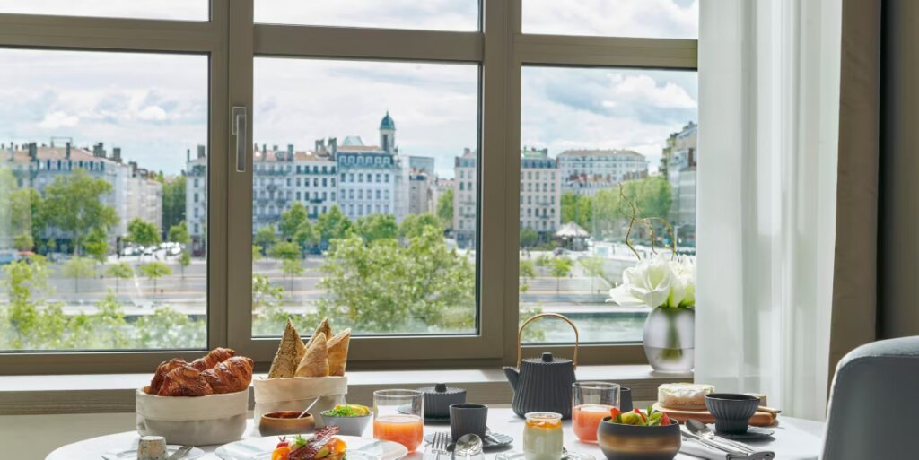 Breakfast scene overlooking buildings in Lyon, France. 