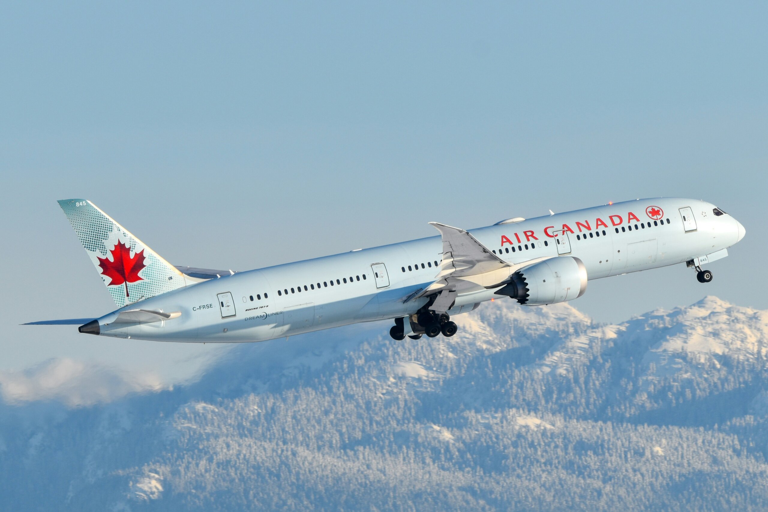 Air Canada airplane flying over mountains