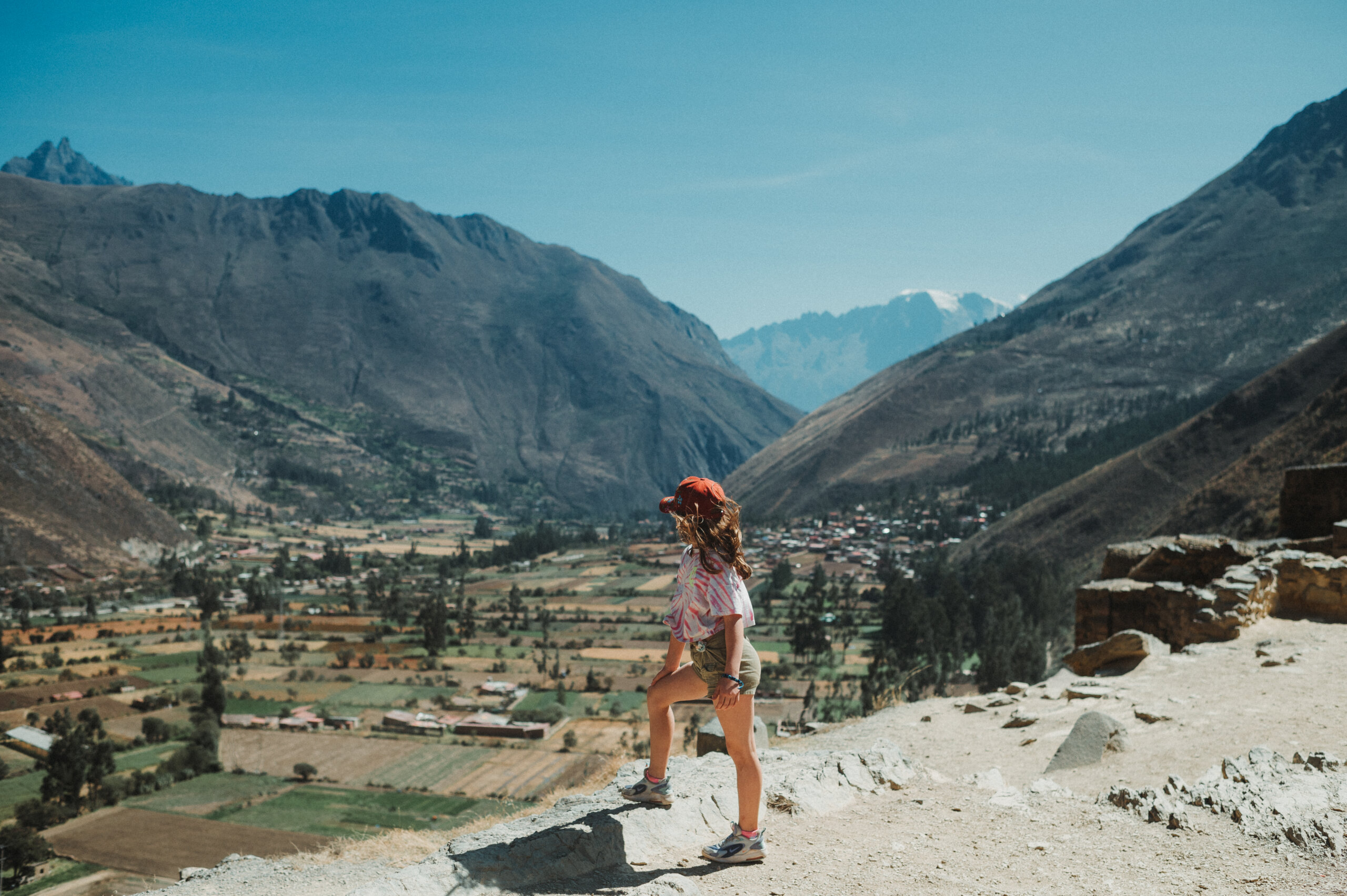 Young girl looking out over Ollantaytambo, Peru