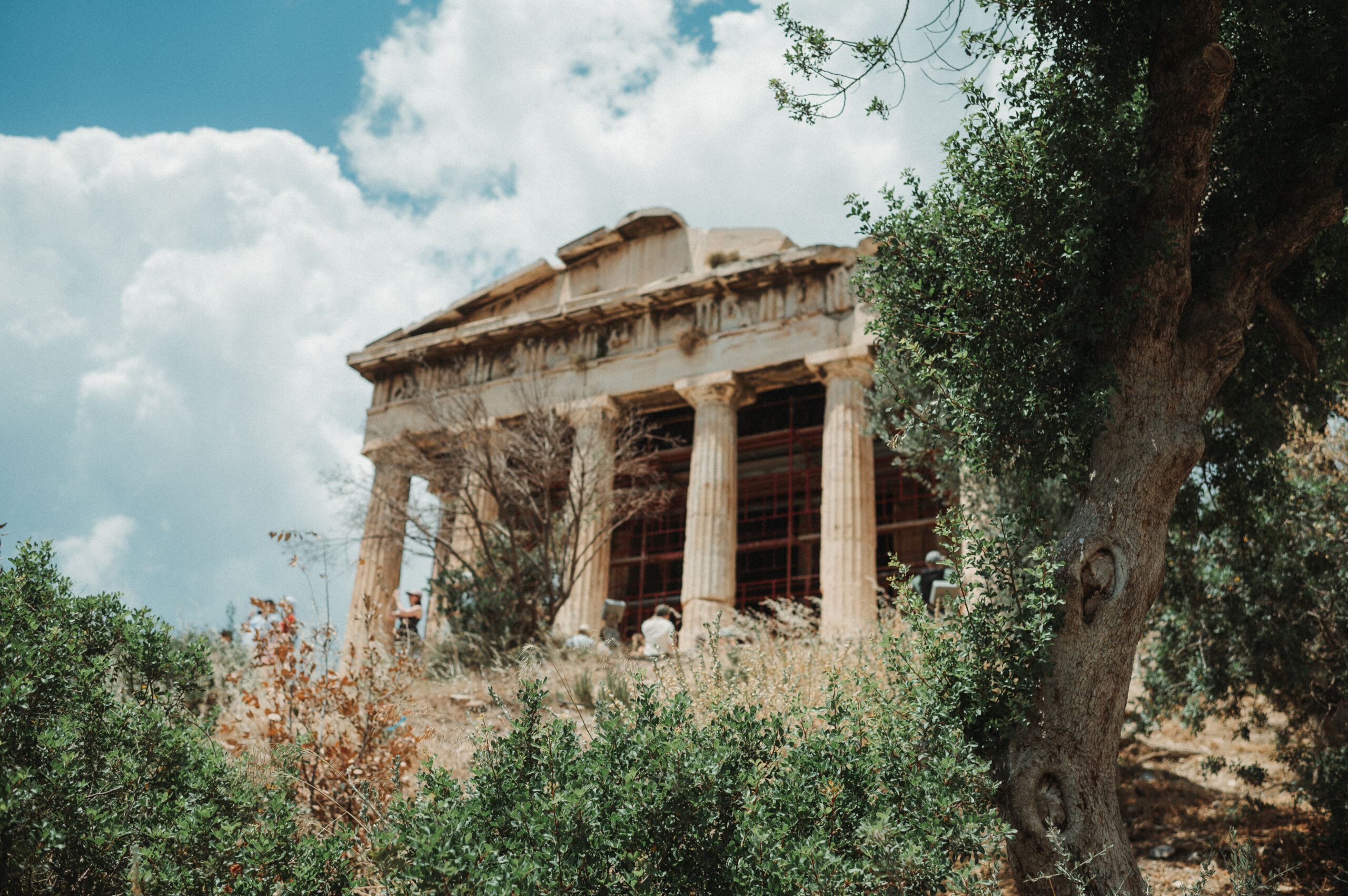 Ancient Greek temple with stone columns and classical architecture.