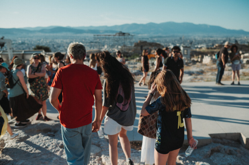 Several people wandering around the Acropolis in Athens.