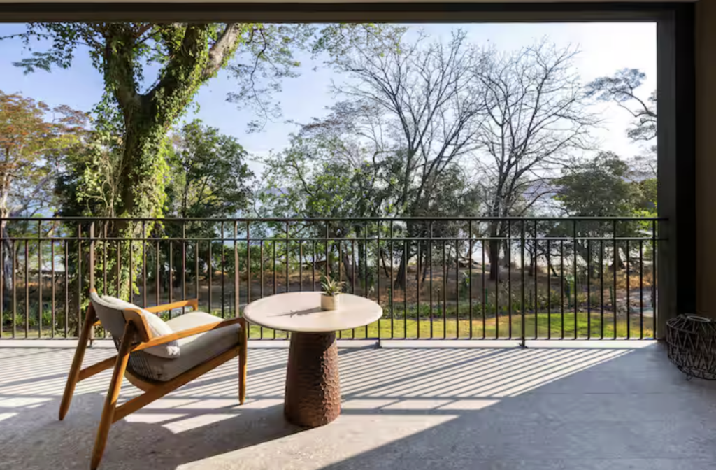Hotel porch with a sitting area overlooking the surrounding natural landscape