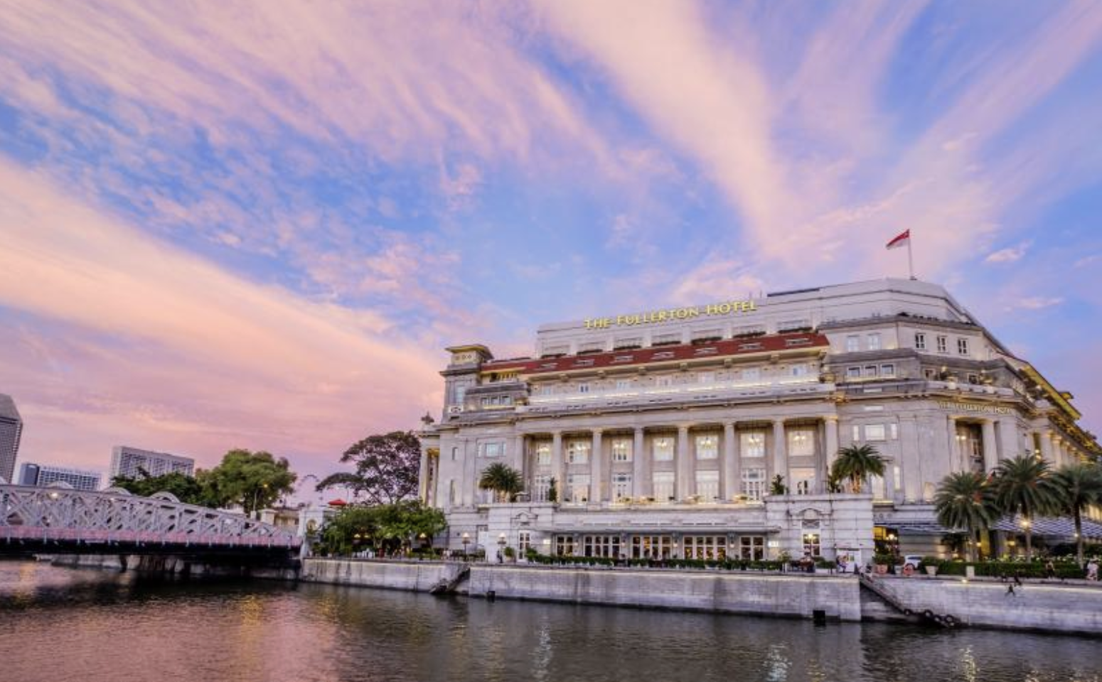 The historic Fullerton Hotel Singapore, a grand white neoclassical building overlooking the Singapore River.