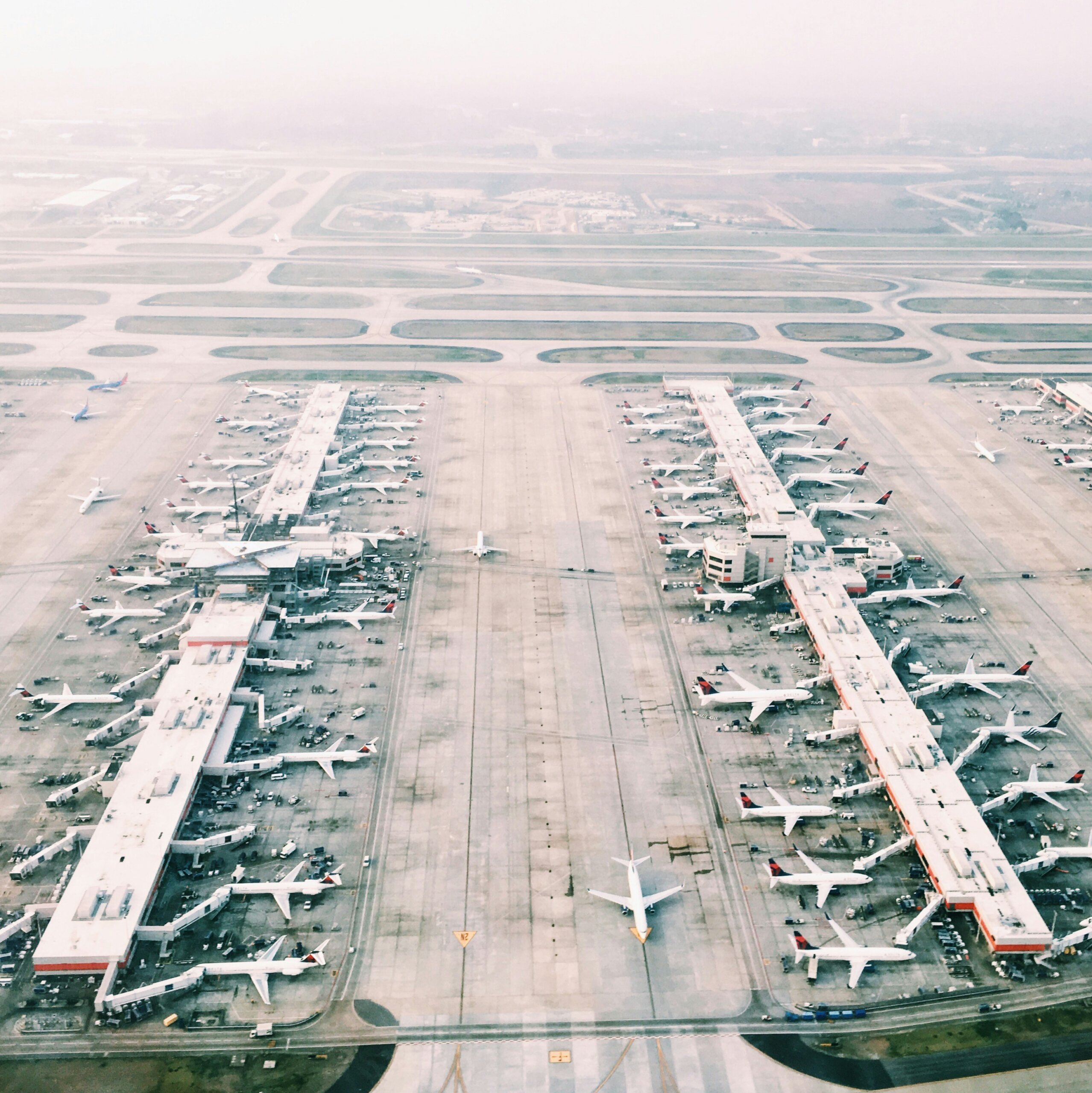 Aerial shot of multiple airplanes parked at gates