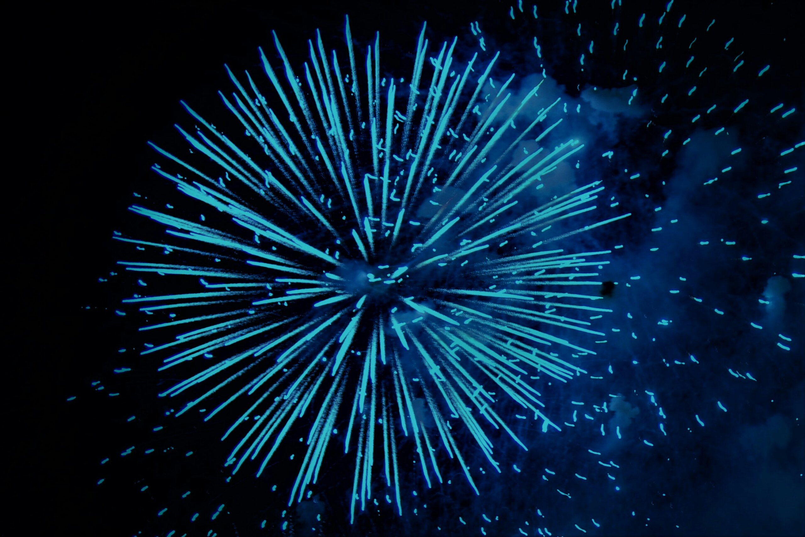 Blue fireworks high in the night sky