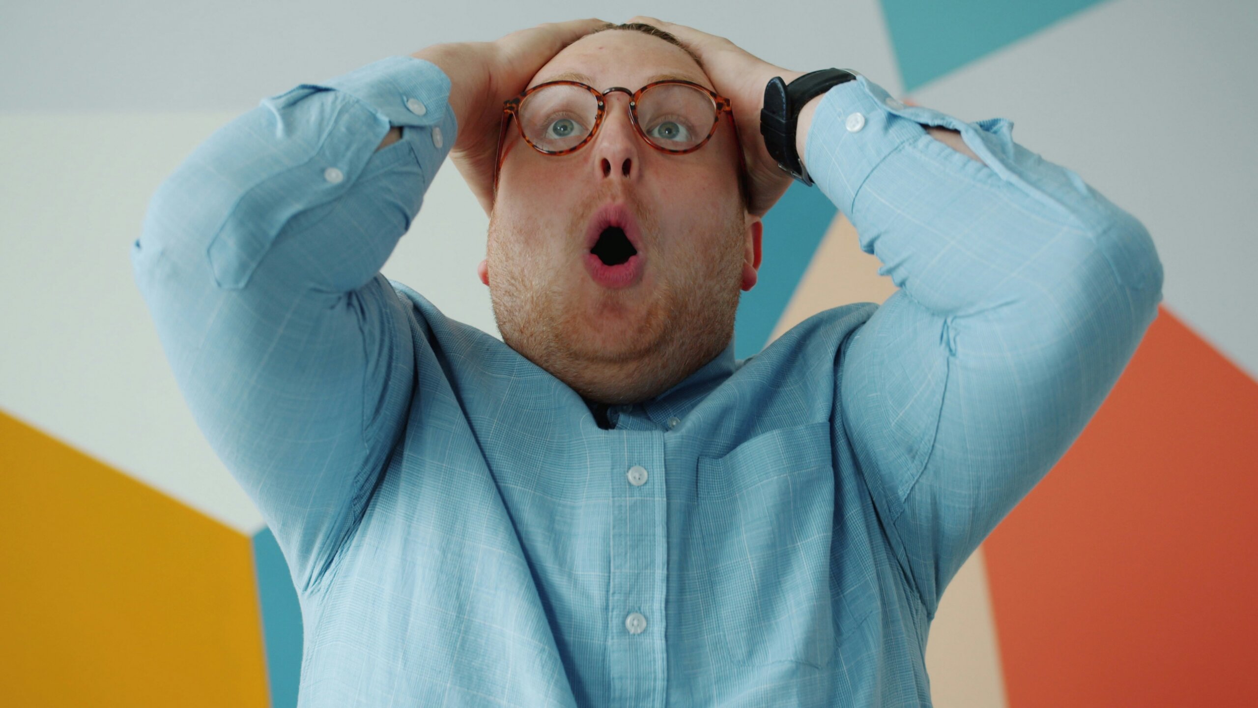 A man in a blue shirt panicking.